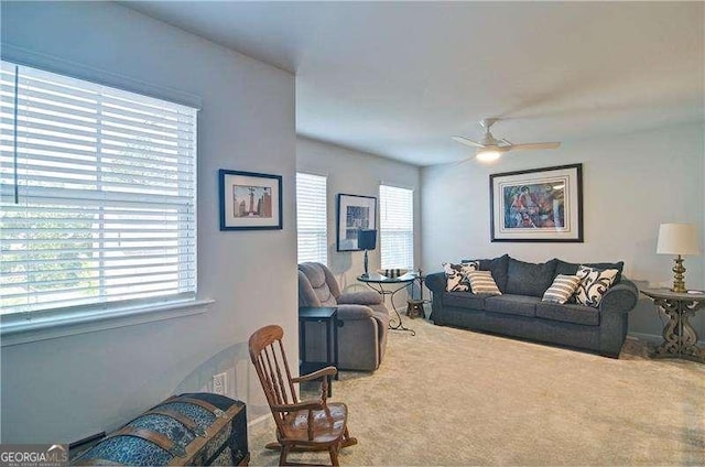 carpeted living area featuring a ceiling fan