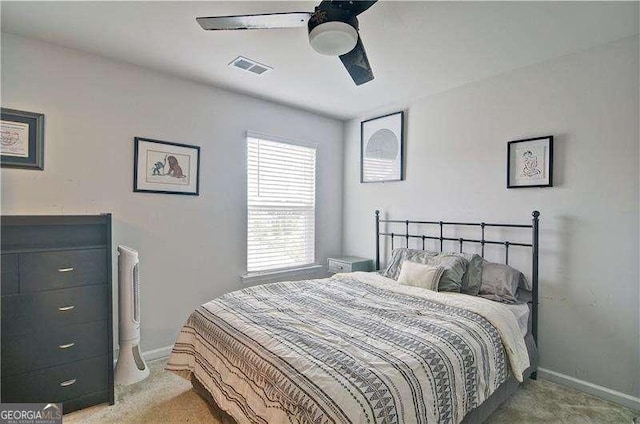 bedroom with light colored carpet, visible vents, and baseboards