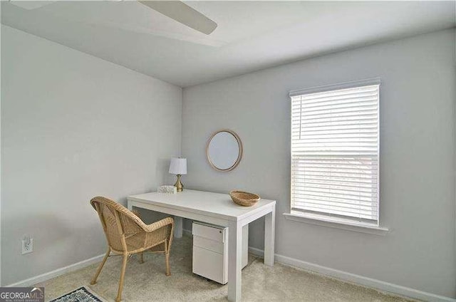 home office featuring light carpet and baseboards