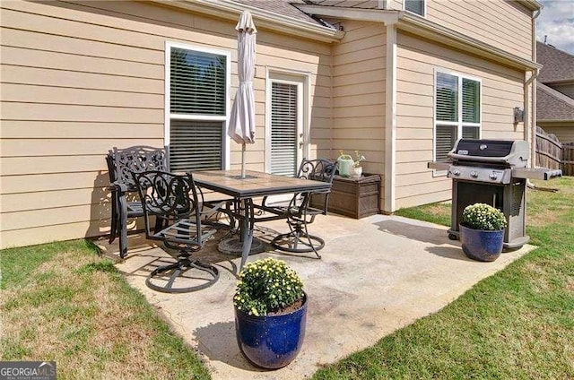 view of patio featuring outdoor dining area and a grill