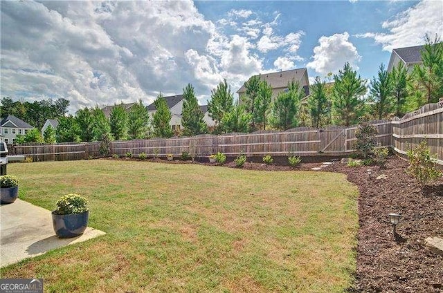 view of yard with a fenced backyard