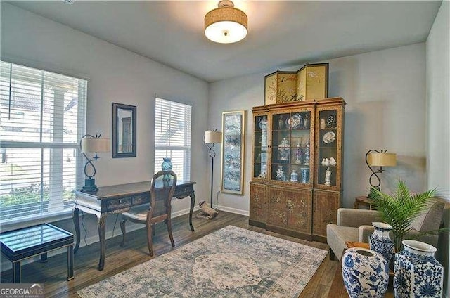 office area with baseboards and wood finished floors