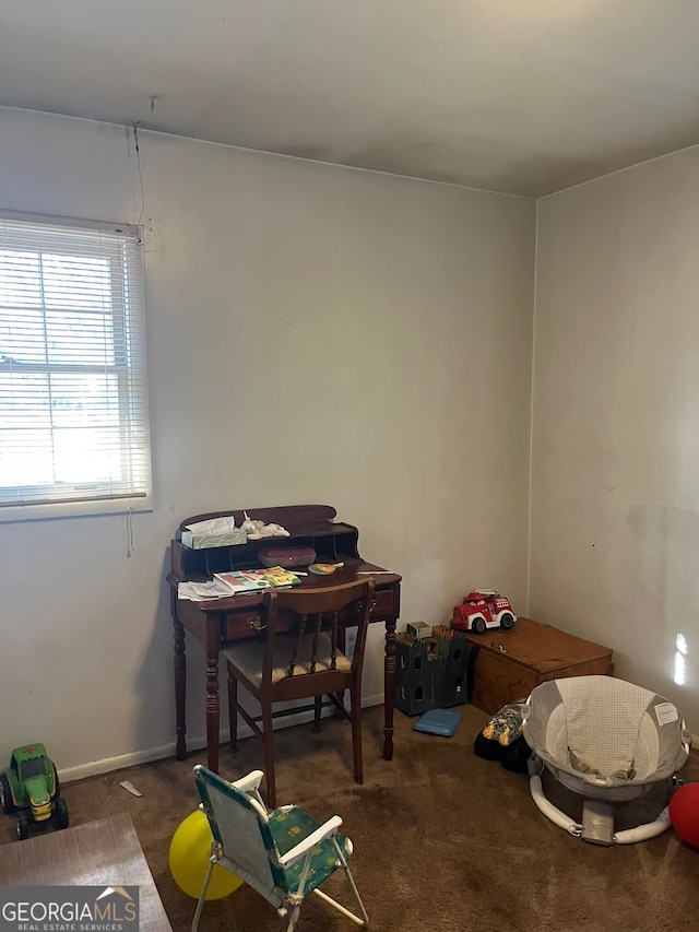 carpeted dining space featuring baseboards