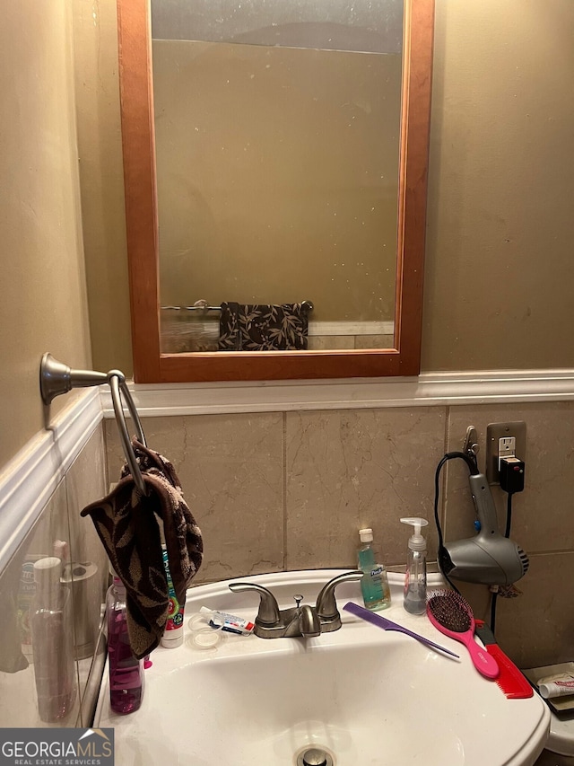 bathroom with wainscoting and a sink