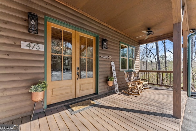 deck featuring covered porch, ceiling fan, and french doors