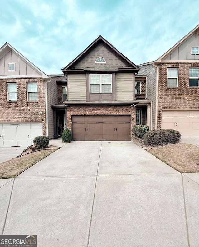 traditional-style home featuring concrete driveway, brick siding, and an attached garage