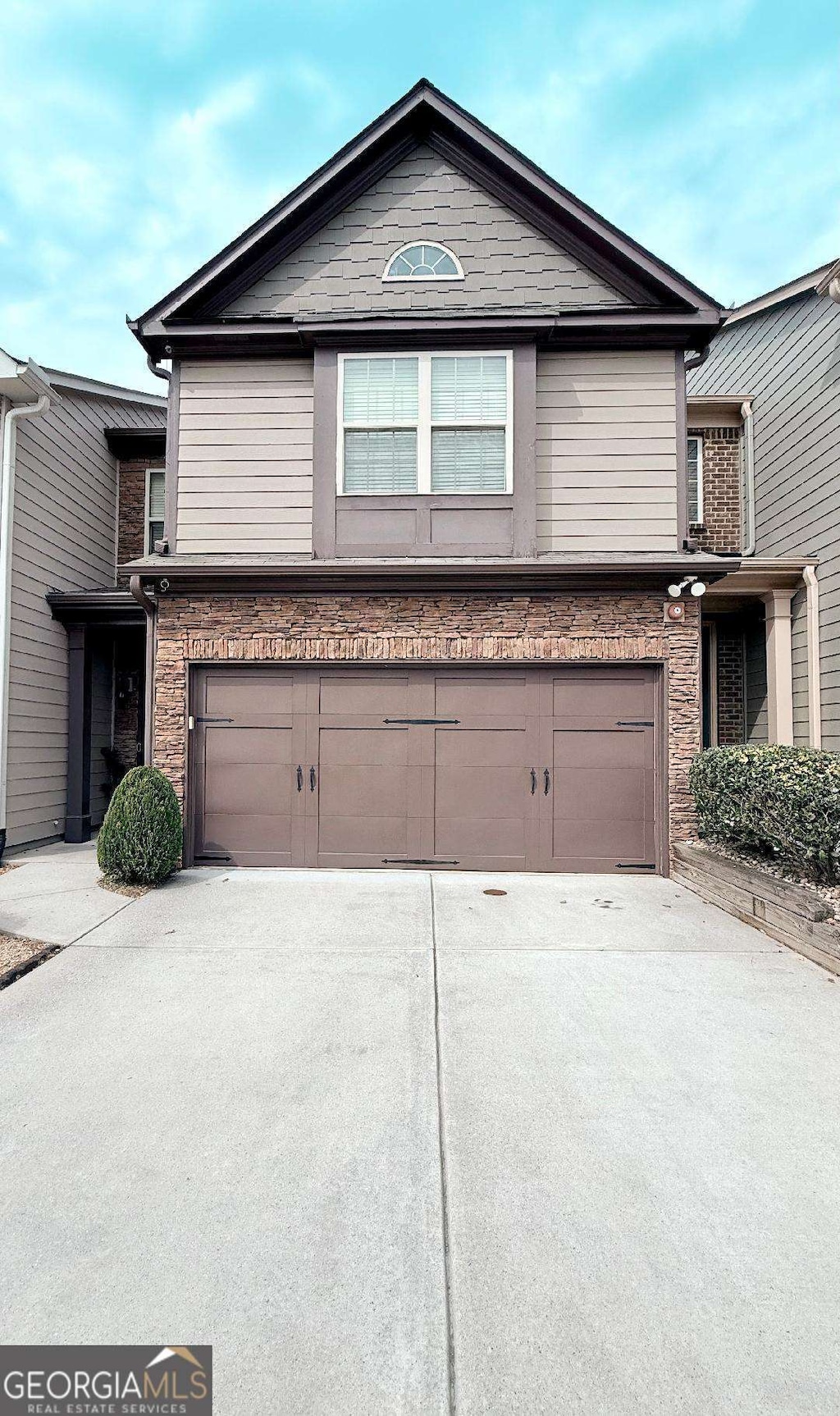6642 Story Cir, Norcross, GA 30093 - view of front of house with an attached garage, driveway, and stone siding