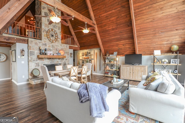 living area featuring wood ceiling, a stone fireplace, wood finished floors, beamed ceiling, and baseboards