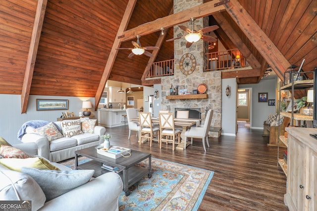 living area with lofted ceiling with beams, wood ceiling, baseboards, and wood finished floors