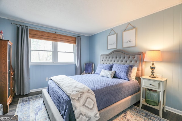 bedroom with wood finished floors and baseboards