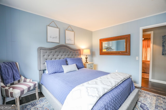 bedroom featuring baseboards and wood finished floors