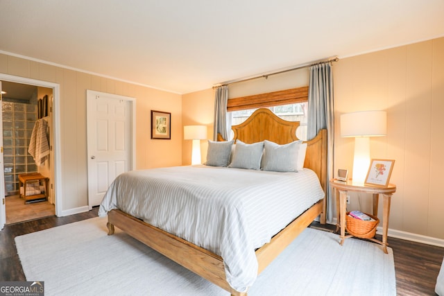 bedroom with ornamental molding, wood finished floors, and baseboards