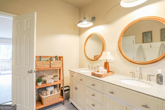 bathroom with a sink and double vanity