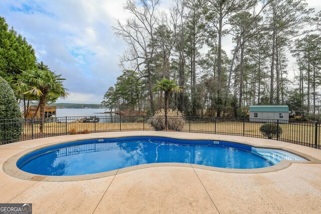 106 Honeysuckle Ln NE, Milledgeville, GA 31061 - view of swimming pool featuring a water view and a patio