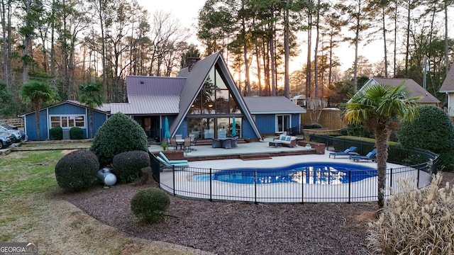 106 Honeysuckle Ln NE, Milledgeville, GA 31061 - rear view of house with a patio area, a metal roof, and a chimney