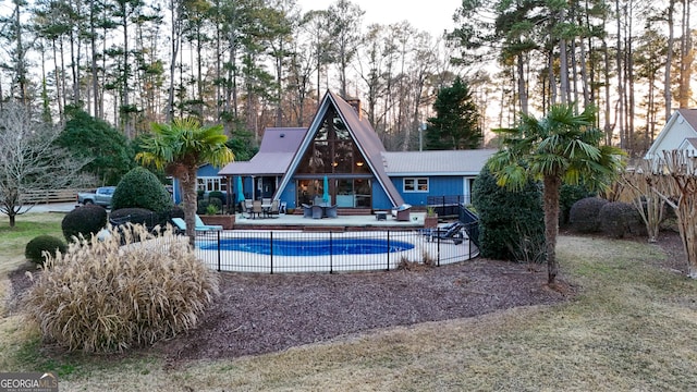 view of swimming pool featuring a patio, fence, and a fenced in pool