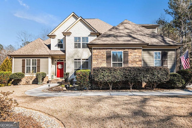 view of front of house featuring stone siding and a shingled roof