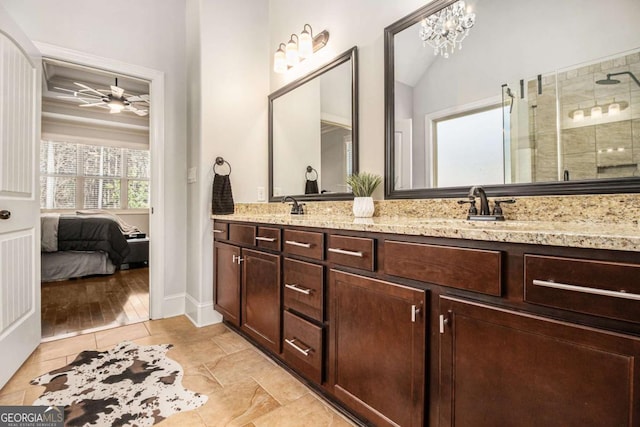 ensuite bathroom featuring double vanity, ensuite bathroom, vaulted ceiling, a tile shower, and a sink