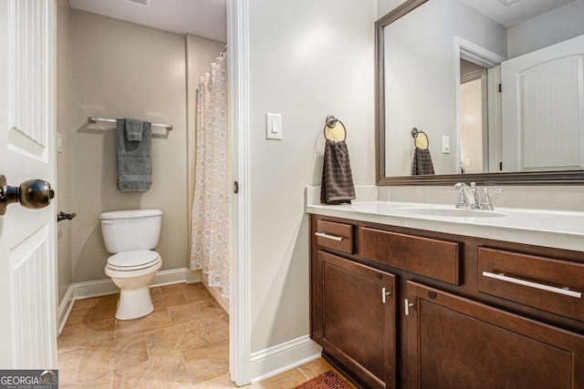 full bathroom featuring toilet, vanity, and baseboards