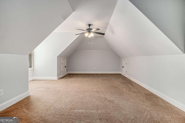 bonus room featuring a ceiling fan, baseboards, vaulted ceiling, and carpet flooring