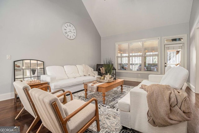 living area featuring dark wood-style floors, high vaulted ceiling, and baseboards