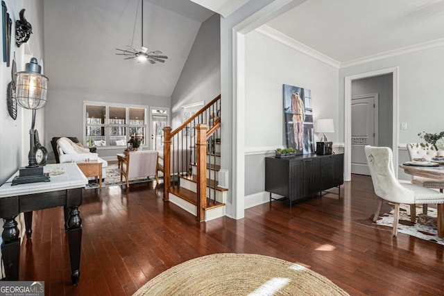 foyer with hardwood / wood-style flooring, ceiling fan, stairs, and crown molding