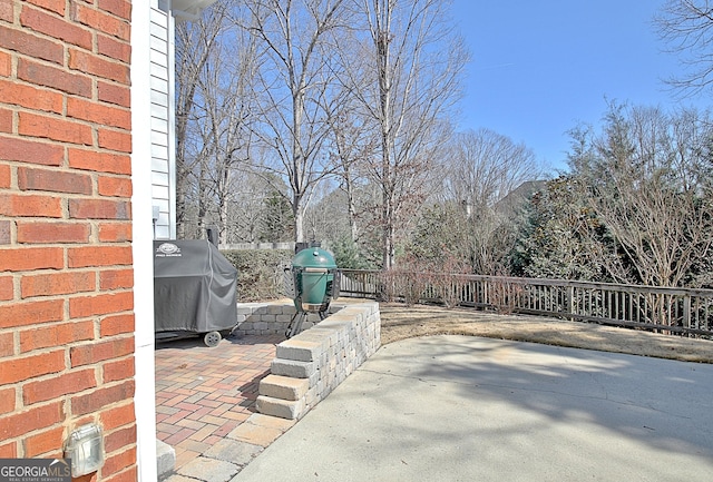 view of patio with grilling area and fence