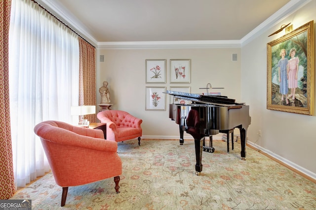 sitting room featuring baseboards and crown molding