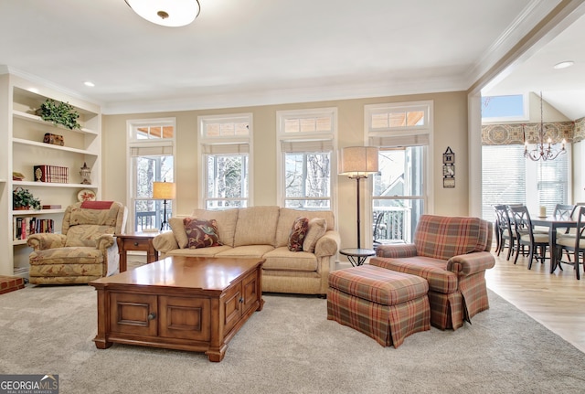 living room featuring built in features, ornamental molding, light wood-type flooring, a chandelier, and recessed lighting