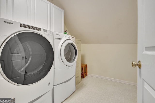 laundry room with washer and clothes dryer, cabinet space, and baseboards