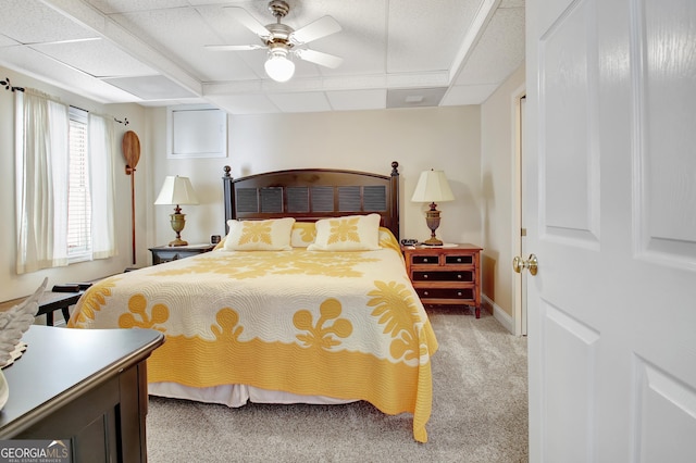 bedroom featuring ceiling fan, baseboards, and light colored carpet