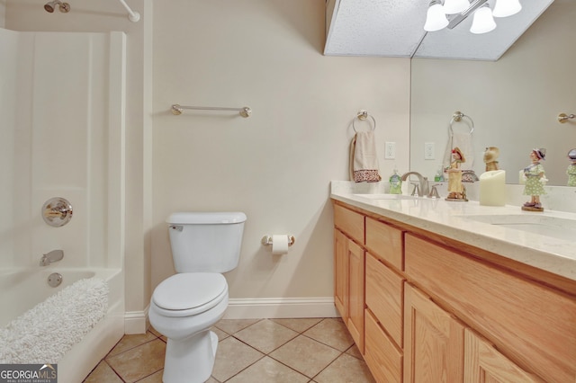 full bath featuring toilet, washtub / shower combination, vanity, baseboards, and tile patterned floors