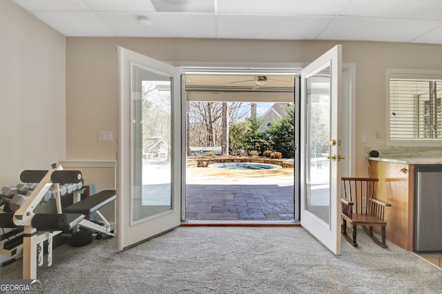 doorway to outside with carpet floors, french doors, and a drop ceiling