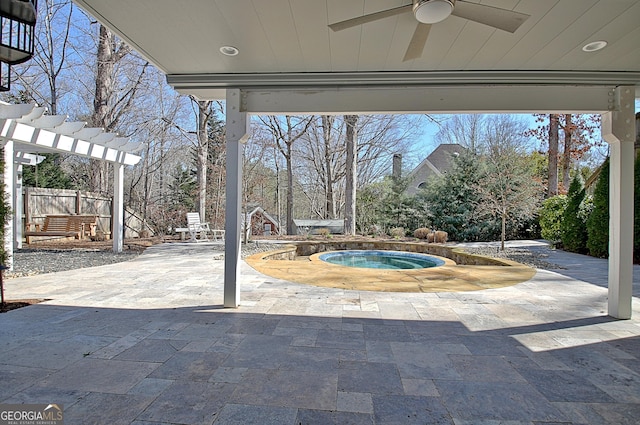 view of patio / terrace featuring a ceiling fan, fence, a pergola, and an in ground hot tub