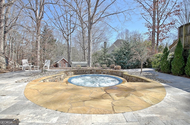 view of swimming pool featuring an in ground hot tub and a patio area