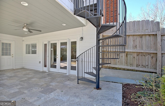 view of patio / terrace featuring a balcony, fence, a ceiling fan, stairs, and french doors