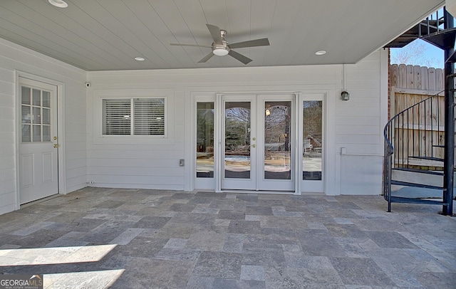 view of patio / terrace with fence, a ceiling fan, and french doors