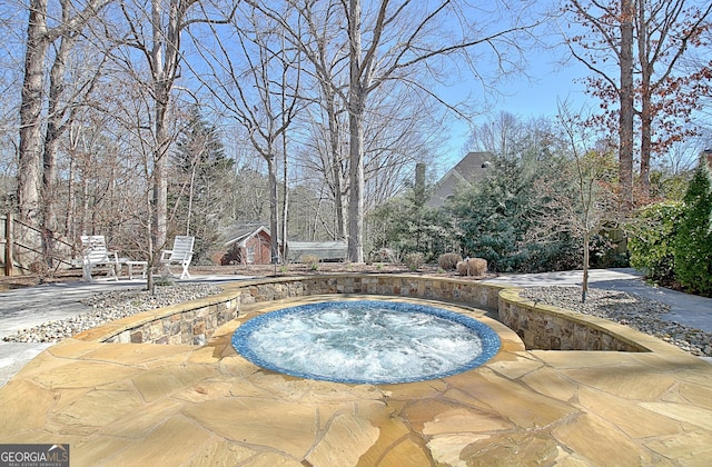 view of pool featuring an in ground hot tub