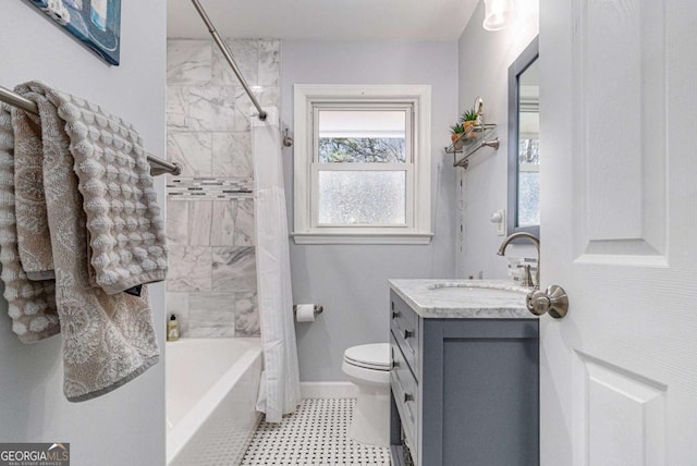 bathroom featuring toilet, shower / bath combo, vanity, and baseboards