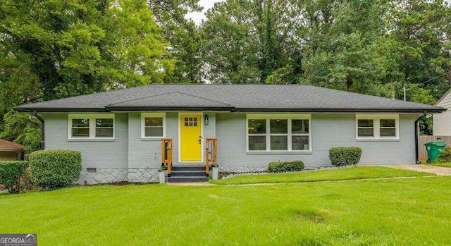 ranch-style house featuring entry steps, brick siding, roof with shingles, crawl space, and a front yard