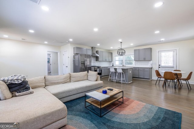 living area with dark wood-style floors, baseboards, and recessed lighting