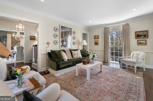 living room with recessed lighting, crown molding, wood finished floors, baseboards, and an inviting chandelier