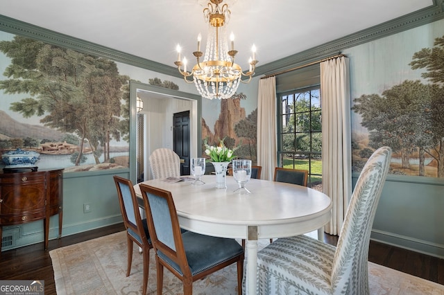 dining room featuring a chandelier, ornamental molding, wood finished floors, and baseboards