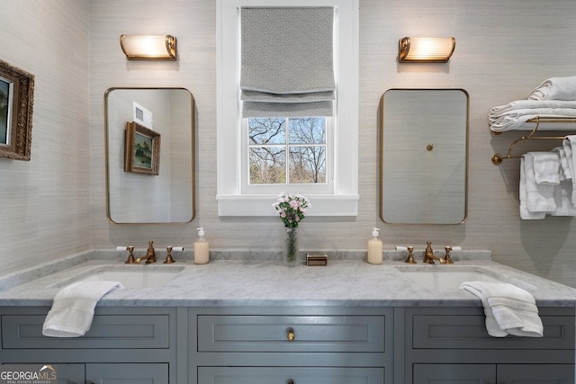 bathroom featuring double vanity, visible vents, and a sink