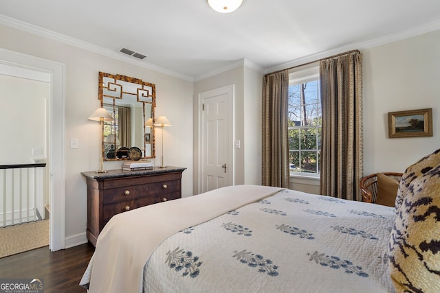 bedroom featuring dark wood-style floors, ornamental molding, and visible vents