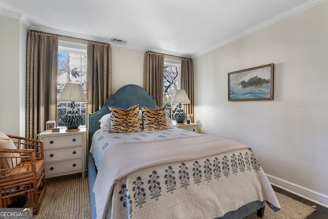 bedroom with ornamental molding, multiple windows, visible vents, and baseboards