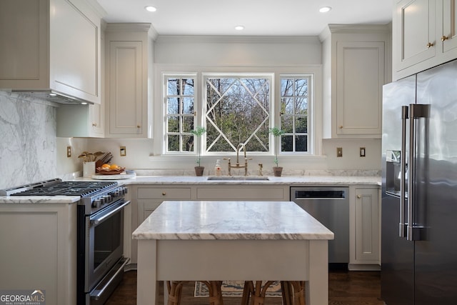 kitchen with a sink, appliances with stainless steel finishes, backsplash, light stone countertops, and crown molding