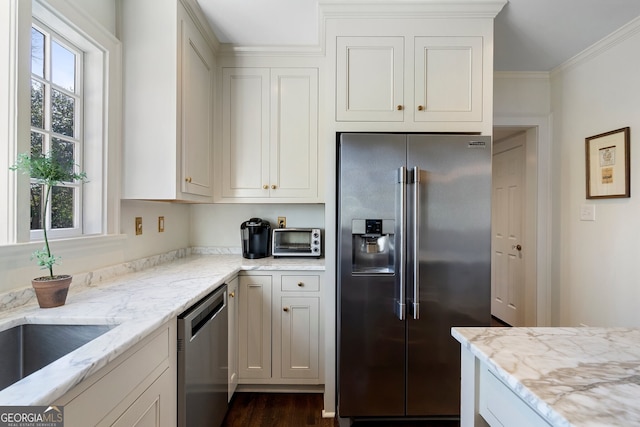 kitchen with a toaster, appliances with stainless steel finishes, ornamental molding, dark wood-style flooring, and light stone countertops