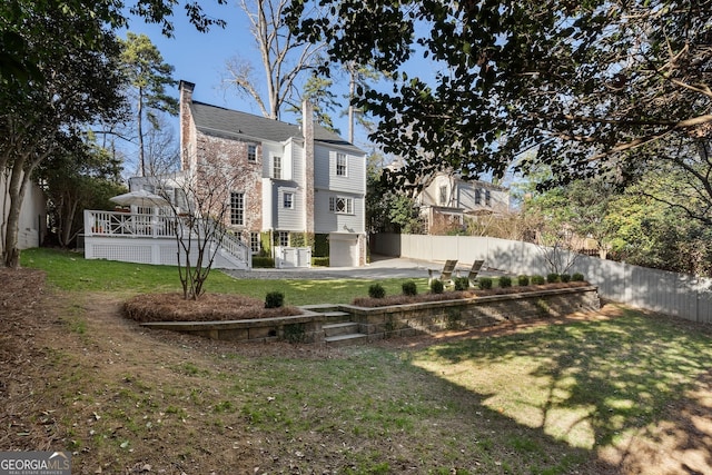 view of yard with fence, stairway, and a wooden deck