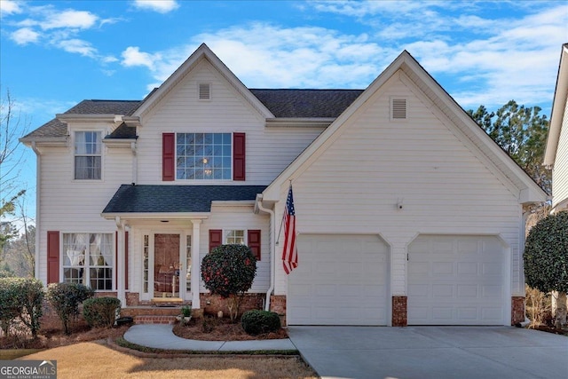 traditional-style home with driveway, an attached garage, a shingled roof, and brick siding